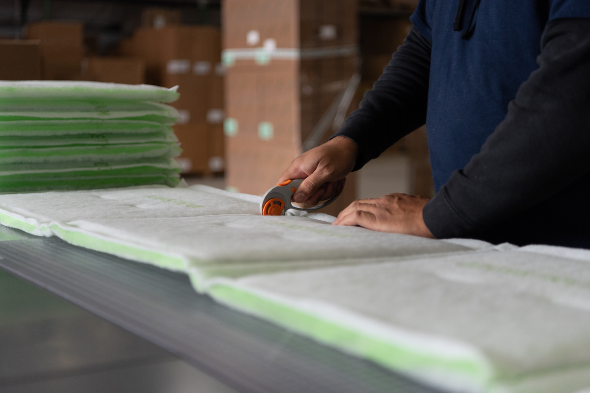 Hands cutting a filter for the distribution center